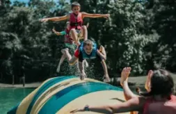 Camp Huawni Overnight Summer Camp -Campers at Camp Huawni jumping on water critter bounce blob.