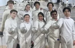 Alliance Fencing Academy students standing in a group pointing their swords to one point.